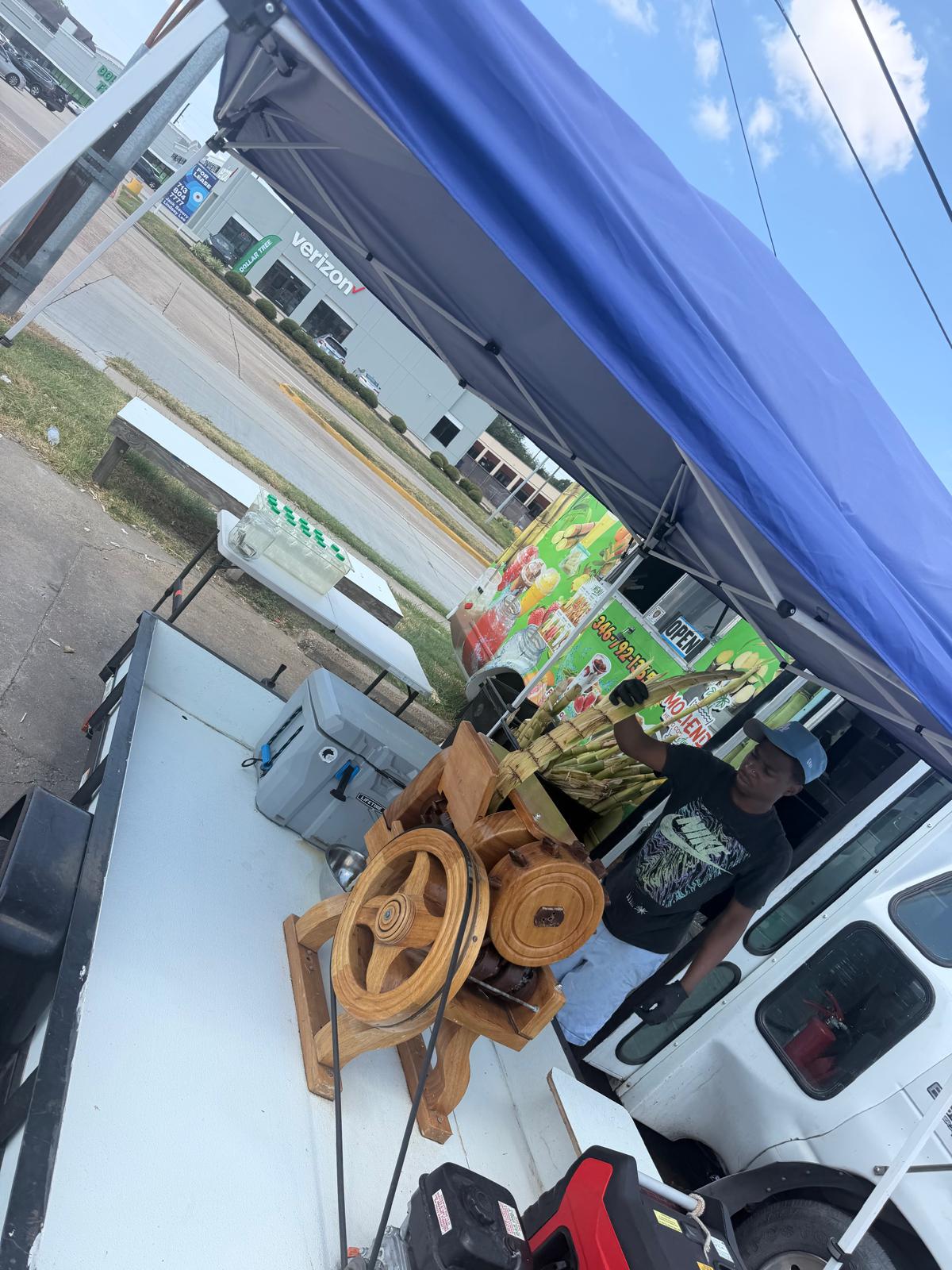 Local sugar cane vendor preparing fresh sugar cane